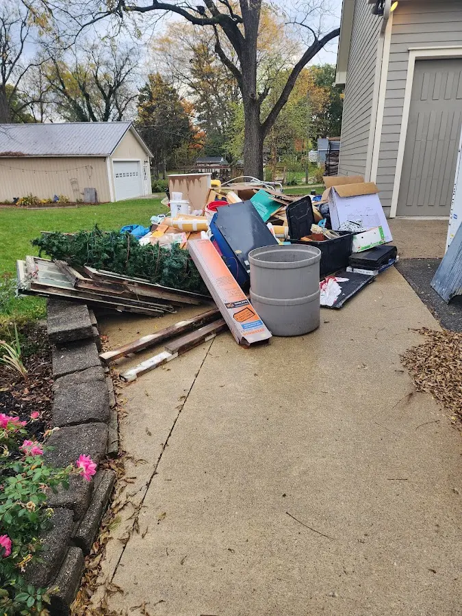 Dumpster being loaded with debris for Roofing Dumpster Rental in St. Francis